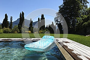 Airbed floating in the pool photo