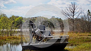 Airboat Parked on Shore in Florida Wetlands