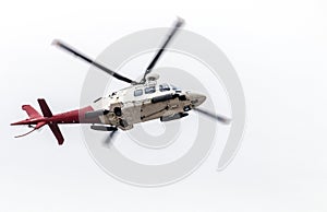 Airborn Helicopter Isolated Against White Overcast Sky