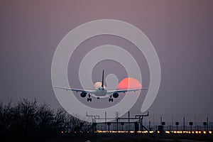 Airbus 320 silhouette on sunset landing on airport closeup