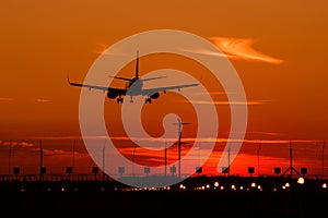 Airbus A320 airplane silhouette at sunset , final approach