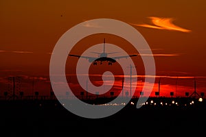 Airbus A320 airplane silhouette at sunset , final approach landing