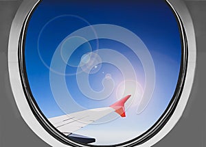 Airbus a380 airplane window during a sunny day above the clouds