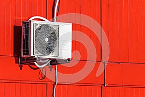 Airconditioning unit on a red wall
