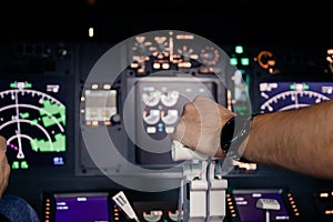 Aircraft captain in cockpit command taking off with airplane, throttling power engine lever