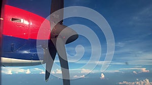 Aircraft engine propeller operates in air against blue sky