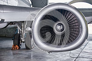 Aircraft engine servicing - opened panels of a large engine of parked aircraft