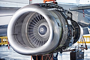 Aircraft engine servicing - opened panels of a large engine of parked aircraft