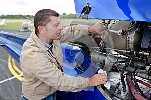 aircraft engineer dismantling jet plane outdoors
