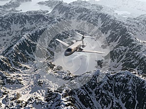 Aircraft flies over a snowy mountains