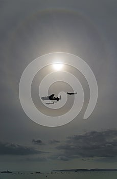 Aircraft fly in front of a sun halo