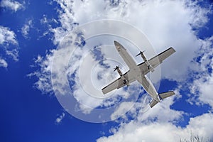 Aircraft flying in blue cloudy sky