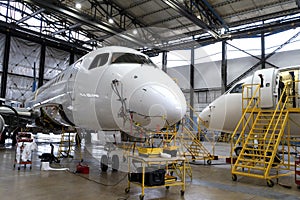 Aircraft is in the hangar for technical repair and maintenance. Aircraft diagnostics, storage, service. Plane. Ladders
