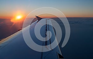 Aircraft jet wing with sunset