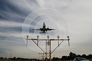 Aircraft is landing at the Rotterdam The Hague Airport over the landing lights