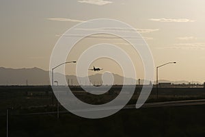 Aircraft landing in sunset photo