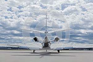 Aircraft learjet Plane in front of the Airport with cloudy sky