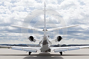 Aircraft learjet Plane in front of the Airport with cloudy sky