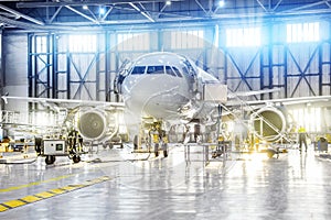 Aircraft on maintenance of engine and fuselage repair in airport hangar