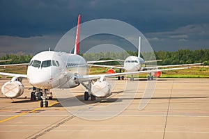 Aircraft maintenance parked in the open air airport, engines in covers repair and mechanics check testing