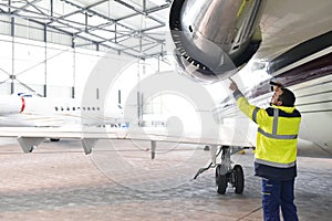 Aircraft mechanic/ ground crew inspects and checks the turbine