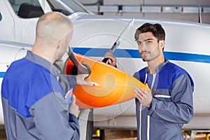 Aircraft mechanics holding propeller