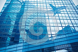 Aircraft reflected in the building curtain wall