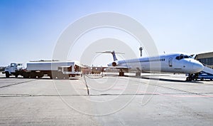 Aircraft refueling with a high pressure tanker. A passenger jet is being refueled from a supply truck. Airport Service