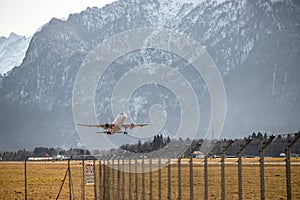 Airplane scenery:  take off from airport, mountain range in the alps. Travel by air, transportation photo