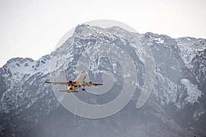 Airplane scenery:  take off from airport, mountain range in the alps. Travel by air, transportation photo