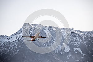 Airplane scenery:  take off from airport, mountain range in the alps. Travel by air, transportation photo