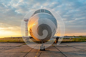 Aircraft on the tarmac of the airport at sunset in the evening