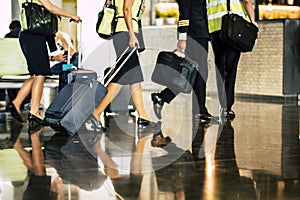 Aircraft team crew boarding scene with captain and hostess assistent fly with luggages reflecting on the floor at the airport gate