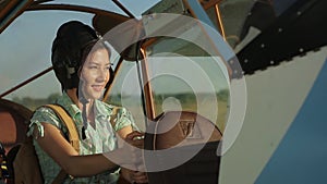 Aircraft and technology concept. Retro vintage style. Active female flier doing sport. Woman pilot portrait walking to