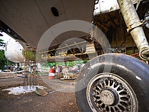 Aircraft Tires Under Repair on an Old Junkyard. Rusty and Broken Retractable Hydraulically Operated Airplane Wheel.