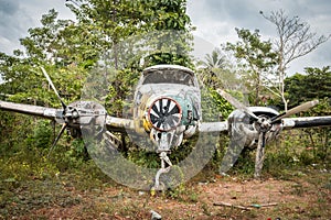 Aircraft wreck in jungle - old propeller airplane in forest