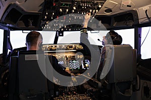 Aircrew members flying airplane with dashboard command