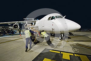 Airfreight loading onto BAE-146 at night.