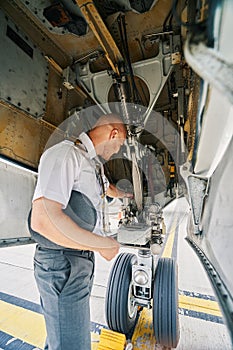 Airline captain examining the landing gear system