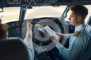 Airline captain and first officer sitting in the cockpit