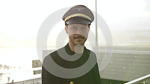 Airline Captain Pilot in Uniform Preparing for Flight at Airport Treminal Gate