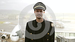 Airline Captain Pilot in Uniform Preparing for Flight at Airport Treminal Gate