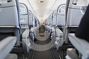 Airline passenger seats and aisle in airplane cabin