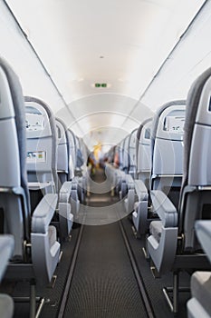 Airline passenger seats and aisle in airplane cabin