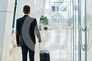 airline passenger walking in the corridor at the airport .