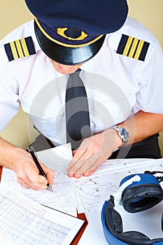 Airline pilot filling in papers