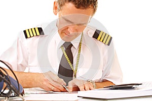 Airline pilot filling in papers