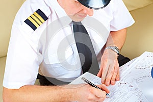 Airline pilot filling in papers in ARO