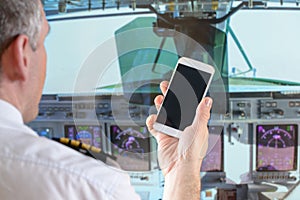 Airline pilot using smart phone