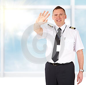 Airline pilot waving